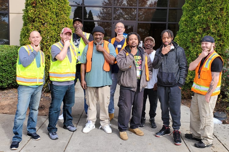 TSG Jonesboro Contract Packaging Operation associates pose for a group photo with their newly-grown beards to bring awareness to men's health issues