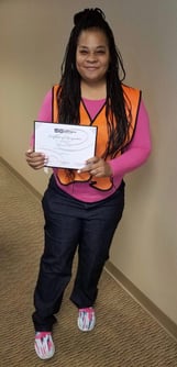 The Shippers Group's Glenda Cokes smiles proudly with her WOW award certificate