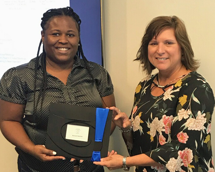 TSG's Payroll Administrator, Eliza Willis accepts recognition for 5 years of service from Diane Villafana, VP of HR & Safety
