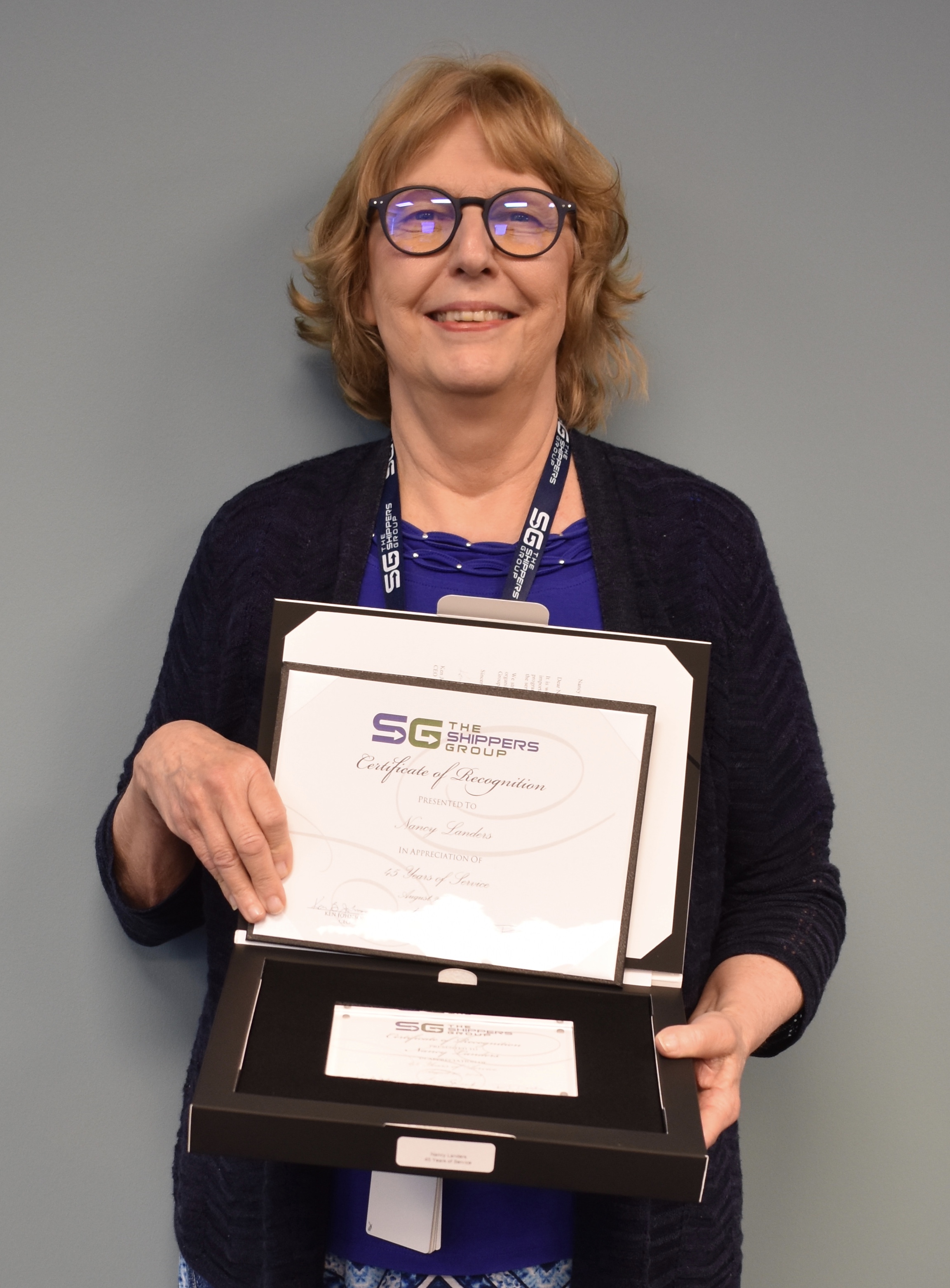 Nancy Landers holding certificate of appreciation